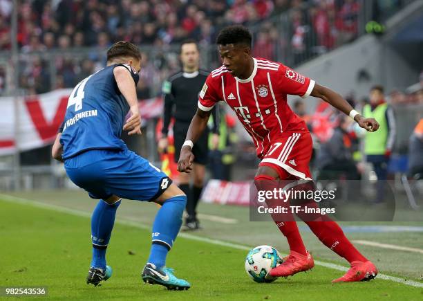 Ermin Bicakcic of Hoffenheim and David Alaba of Muenchen battle for the ball during the Bundesliga match between FC Bayern Muenchen and TSG 1899...