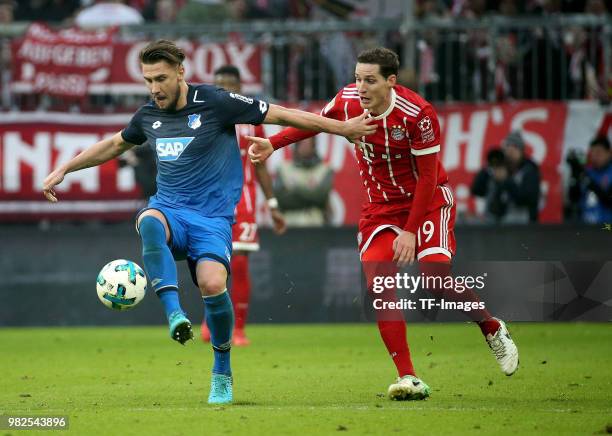 Ermin Bicakcic of Hoffenheim and Sebastian Rudy of Muenchen battle for the ball during the Bundesliga match between FC Bayern Muenchen and TSG 1899...