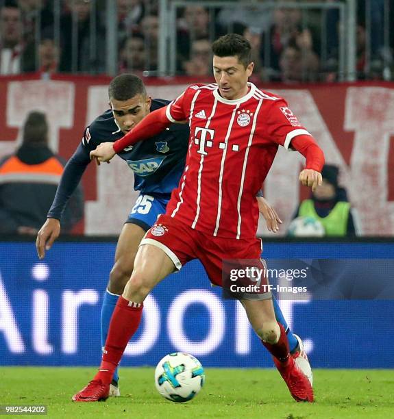 Robert Lewandowski of Muenchen and Kevin Akpoguma of Hoffenheim battle for the ball during the Bundesliga match between FC Bayern Muenchen and TSG...