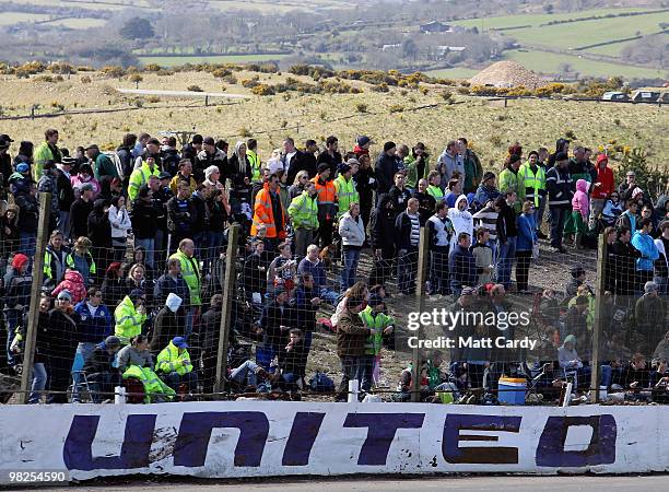 Spectators gather for a view as they watch one of the 2-litre National Bangers Heat races at the United Downs Raceway banger racing meet in St Day...