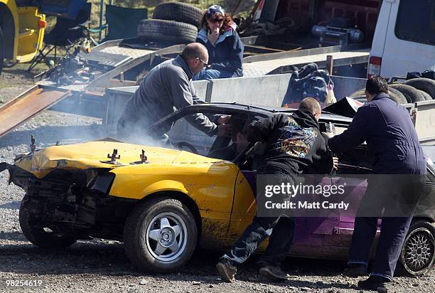 Banger racing team try to get a car ready for another heat at the United Downs Raceway banger racing meet in St Day near Redruth on April 4, 2010 in...