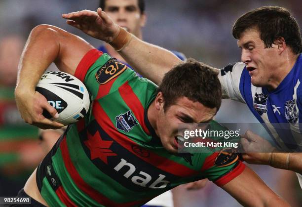 Sam Burgess of the Rabbitohs is tackled by Josh Morris of the Bulldogs during the round four NRL match between the South Sydney Rabbitohs and the...