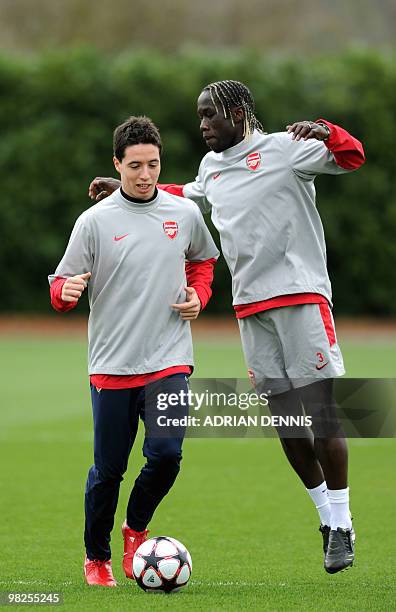 Arsenal's French defenders Bacary Sagna skips behind Samir Nasri during a training session at the club's complex in London Colney on April 5, 2010....