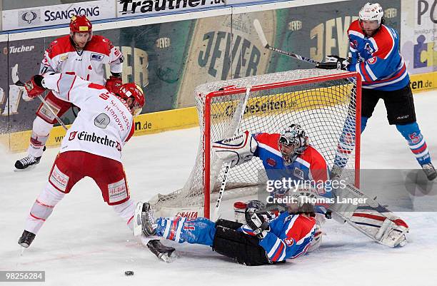 Adam Mitchell and Aris Brimanis of Hannover, Andre Savage, Patrick Ehelechner and Alain Nasreddine of Nuremberg battle for the puck during the fourth...