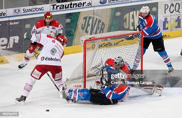 Adam Mitchell and Aris Brimanis of Hannover, Andre Savage, Patrick Ehelechner and Alain Nasreddine of Nuremberg battle for the puck during the fourth...