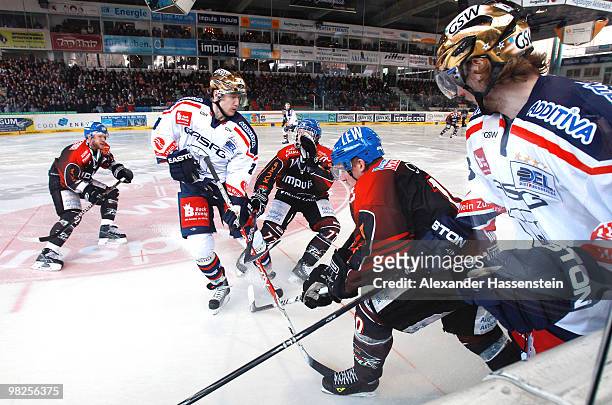 Rhett Gordon of Augbsurg battles for the puck with Florian Busch of Berlin and his team mate Frank Hoerdler during the fourth DEL quarter final...