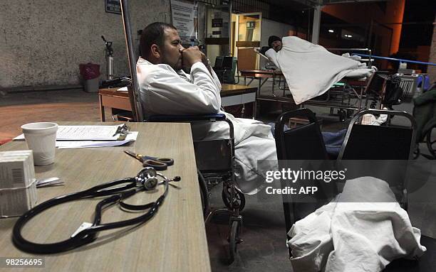 Doctor of the Social Security hospital in Mexicali, in Mexico's Baja California state, waits for patients on April 5, 2010 outside the building after...