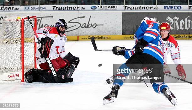 Brad Leeb scores his team's second goal against goalie Scott Travis of Hannover during the fourth DEL quarter final play-off game between Thomas Sabo...