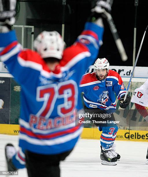 Shane Peacock of Nuremberg celebrates after scoring his team's first goal with team mate Brad Leeb during the fourth DEL quarter final play-off game...