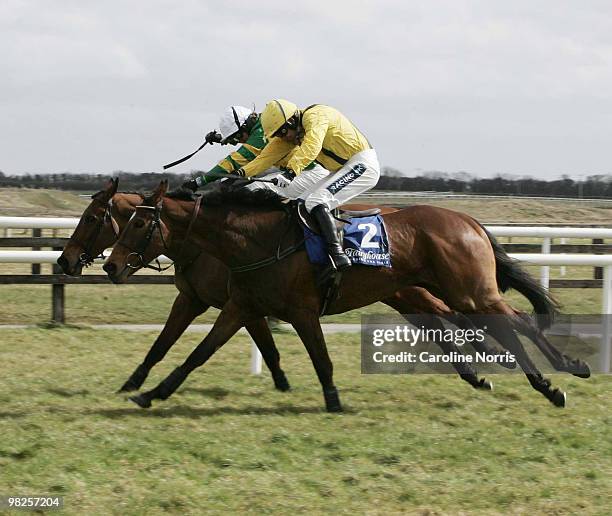 Ruby Walsh on Cousin Vinny on their way to winning past Tony McCoy on Head Of The Posse during the Keelings Irish Strawberry Hurdle Chase at the 2010...