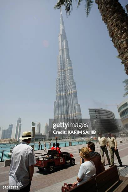 Tourists look at Dubai's Burj Khalifa , the world's tallest tower, on April 5, 2010. Dozens of visitors lined up to ascend the viewing deck of the...