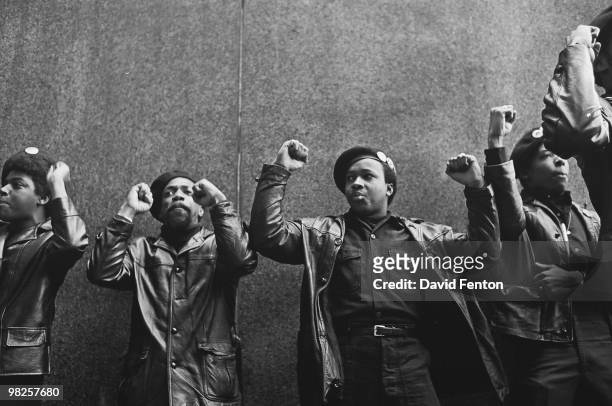 View of a line of Black Panther Party members as they demonstrate, fists raised, outside the New York County Criminal Court , New York, New York,...