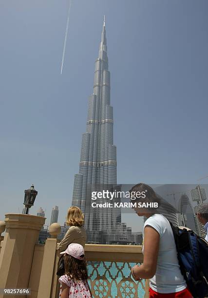 Tourists look at Dubai's Burj Khalifa , the world's tallest tower, on April 5, 2010. Dozens of visitors lined up to ascend the viewing deck of the...