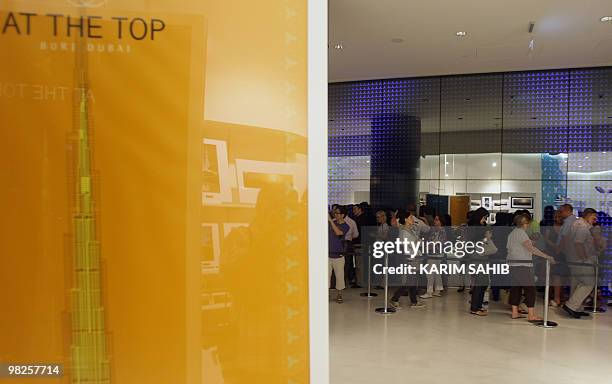 Dozens of people queue on April 5, 2010 to ascend the viewing deck of Dubai's Burj Khalifa, the world's tallest tower, which reopened after an...