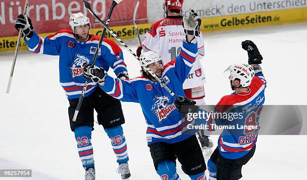 Eric Chouinard, Adrian Grygiel and Alain Nasreddine of Nuremberg celebrate after Grygiel scores his team's fouth goal during the fourth DEL quarter...