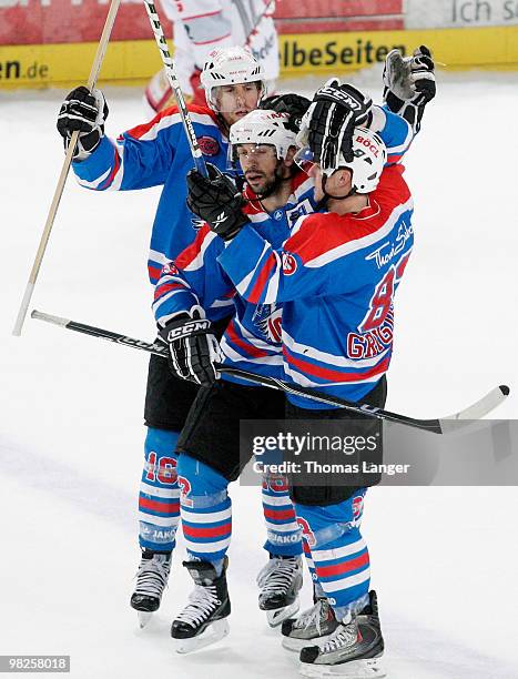 Eric Chouinard, Adrian Grygiel and Alain Nasreddine of Nuremberg celebrate after Grygiel scores his team's fourth goal during the fourth DEL quarter...