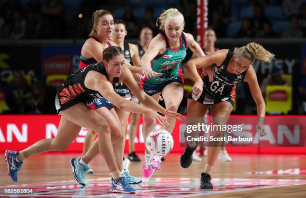 Matilda Garrett and Erin Bell of the Magpies and Joanna Weston of the Vixens compete for the ball during the round eight Super Netball match between...