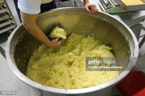 Sandra Schuck prepares apple pie at the company 'Mecklenburger Backstuben' in Waren, Germany, 31 January 2018. The company does not only have 60...