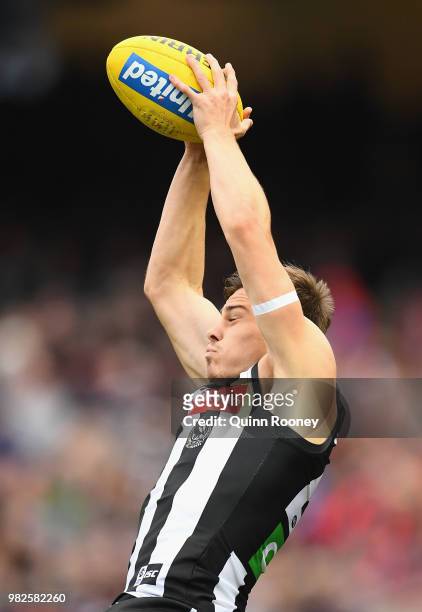 Josh Thomas of the Magpies marks during the round 14 AFL match between the Collingwood Magpies and the Carlton Blues at Melbourne Cricket Ground on...