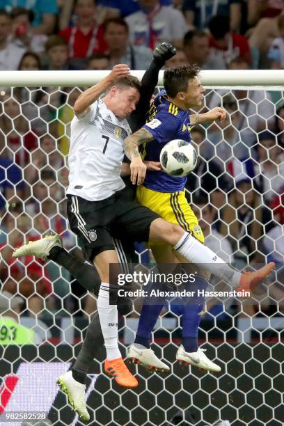 Julian Draxler of Germany battles for the ball with Albin Ekdal of Sweden and his keeper Robin Olsen of Germany runs with the ball during the 2018...