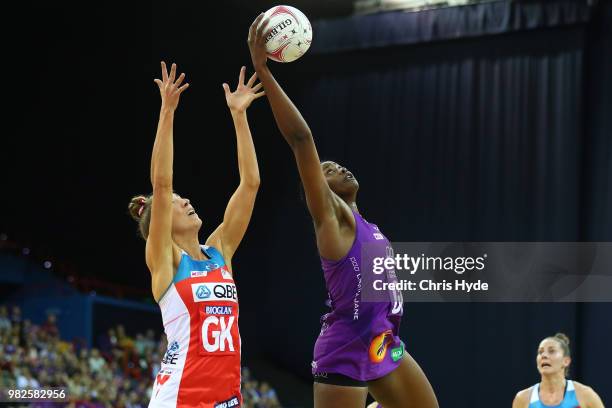 Sarah Klau of the Swifts and Romelda Aiken of the Firebirds compete for the ball during the round eight Super Netball match between the Firebirds and...