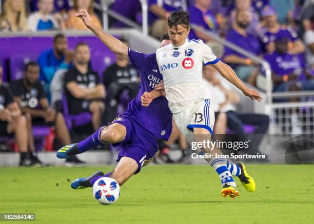 Orlando City midfielder Sacha Kljestan slide tackles Montreal Impact midfielder Ken Krolicki During the MLS soccer match between the Orlando City SC...