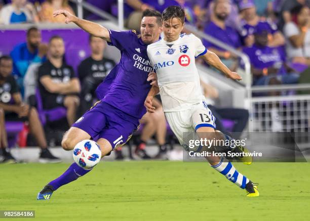 Orlando City midfielder Sacha Kljestan and Montreal Impact midfielder Ken Krolicki battle for possession During the MLS soccer match between the...