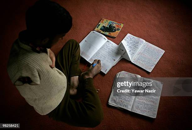 Irshad Ahmad writes with his right foot on his note book on March 29, 2010 Seever, Lolab, 140 km north of Srinagar the summer capital of Indian...