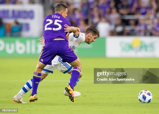 Orlando City defender Donny Toia tries to dispossess Montreal Impact defender Daniel Lovitz During the MLS soccer match between the Orlando City SC...