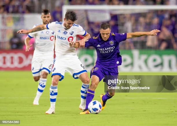 Orlando City defender Donny Toia is challenged by Montreal Impact defender Daniel Lovitz During the MLS soccer match between the Orlando City SC and...