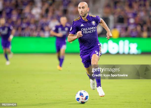 Orlando City forward Justin Meram looks to mass the ball During the MLS soccer match between the Orlando City SC and Montreal Impact on June 23rd,...