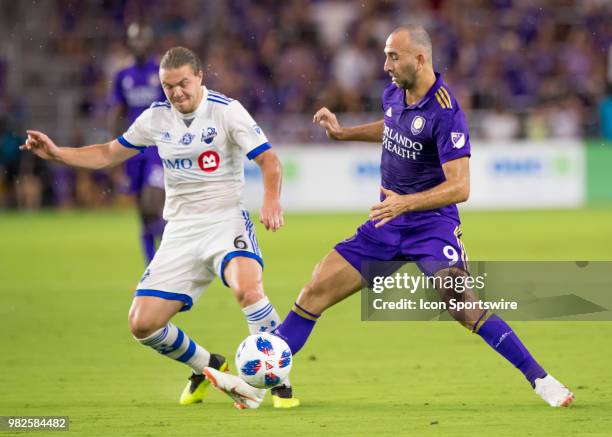 Montreal Impact midfielder Samuel Piette tries to dispossess Orlando City forward Justin Meram During the MLS soccer match between the Orlando City...