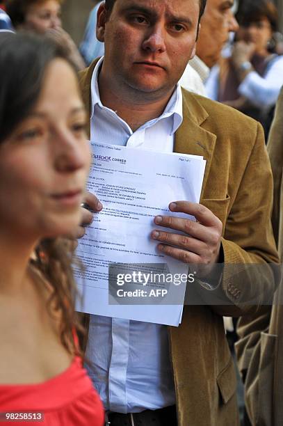 People queue at the Spanish consulate in Caracas to demand about procedures to obtain an European nationality on March 23, 2010. Descendants of...
