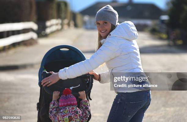 The Olympic champion and former biathlete Evi Sachenbacher-Stehle pushes her daughter Mina in a buggy in Fischen, Germany, 31 January 2018. Photo:...