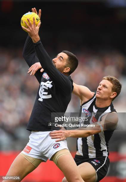 Kade Simpson of the Blues marks infront of Will Hoskin-Elliott of the Magpies during the round 14 AFL match between the Collingwood Magpies and the...