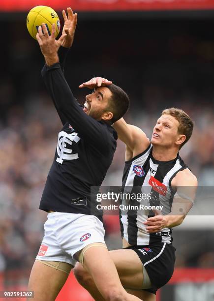 Kade Simpson of the Blues marks infront of Will Hoskin-Elliott of the Magpies during the round 14 AFL match between the Collingwood Magpies and the...