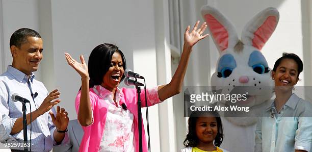 First lady Michelle Obama speaks from the Truman Balcony as President Barack Obama , daughters Malia and Sasha look on during the annual White House...