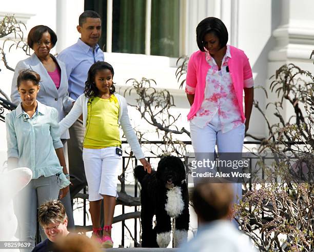 President Barack Obama, first lady Michelle, first dog Bo, daughters Sasha and Malia, and Marian Robinson, mother of Mrs. Obama, walk down the stairs...