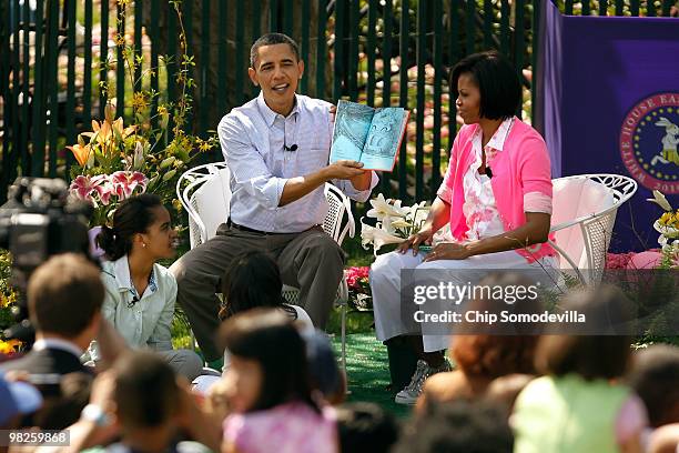 President Barack Obama reads "Green Eggs and Ham," by Dr. Suess, for a group of children and his family, first lady Michelle Obama and daughters...