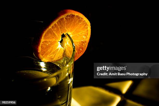 a slice of orange against  - amit basu stockfoto's en -beelden