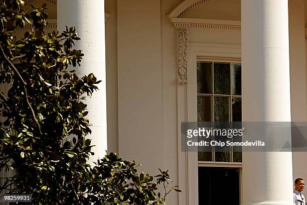 President Barack Obama stands on the White House's south-facing balcony during the Easter Egg Roll April 5, 2010 in Washington, DC. About 30,000...