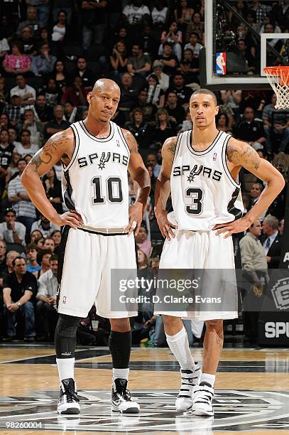 Keith Bogans and George Hill of the San Antonio Spurs stand on the court during the game against the Cleveland Cavaliers on March 26, 2010 at the...