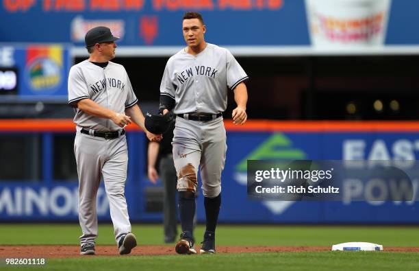 Aaron Judge of the New York Yankees is looked after by third base coach Phil Nevin after a hard slide into second base in the first inning against...