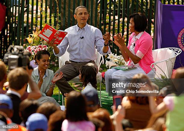 President Barack Obama gets a round of applause after reading "Green Eggs and Ham," by Dr. Suess, for a group of children and his family, first lady...