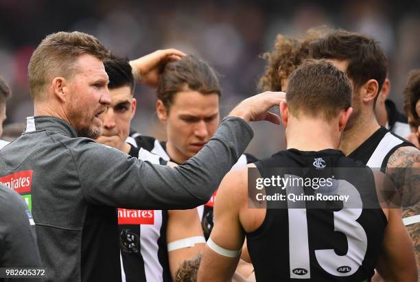 Magpies head coach Nathan Buckley talks to his players during the round 14 AFL match between the Collingwood Magpies and the Carlton Blues at...