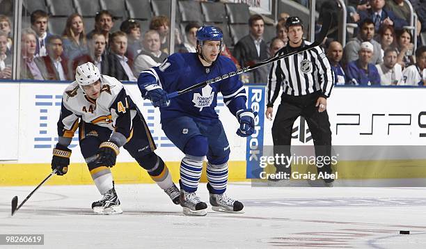 Nikolai Kulemin of the Toronto Maple Leafs skates with Andrej Sekera of the Buffalo Sabres during the game on April 1, 2010 at the Air Canada Centre...