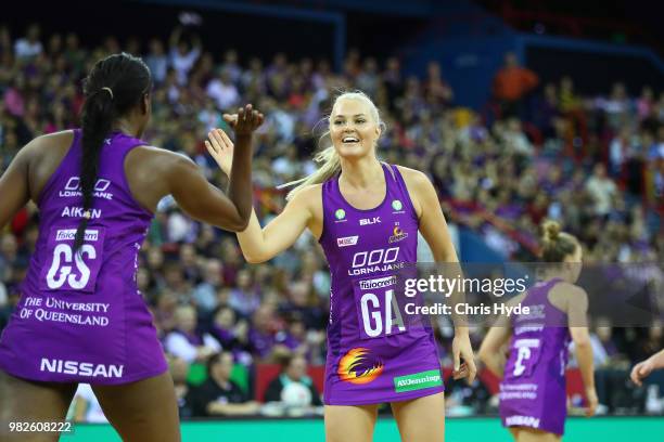 Romelda Aiken and Gretel Tippett of the Firebirds celebrate a goal during the round eight Super Netball match between the Firebirds and the Swifts at...