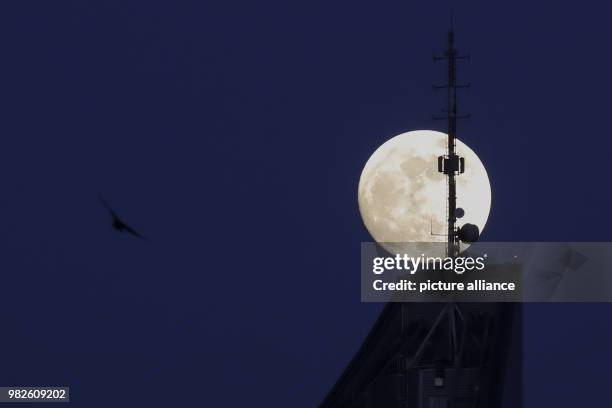 The almost round full moon shining over the City skyscraper in Leipzig, Germany, 30 January 2018. The full moon on 31 January 2018 will be a...