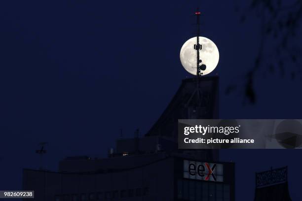 The almost round full moon shining over the City skyscraper in Leipzig, Germany, 30 January 2018. The full moon on 31 January 2018 will be a...