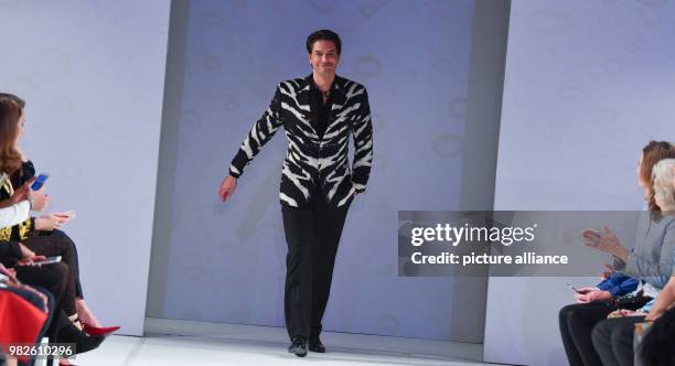 Marcus Schenkenberg, first male supermodel, showing a creation of Gianni Versace during the fashion show at the opening of the exhibition on the...
